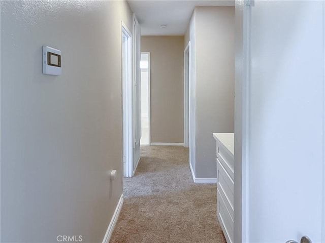 hall with light colored carpet