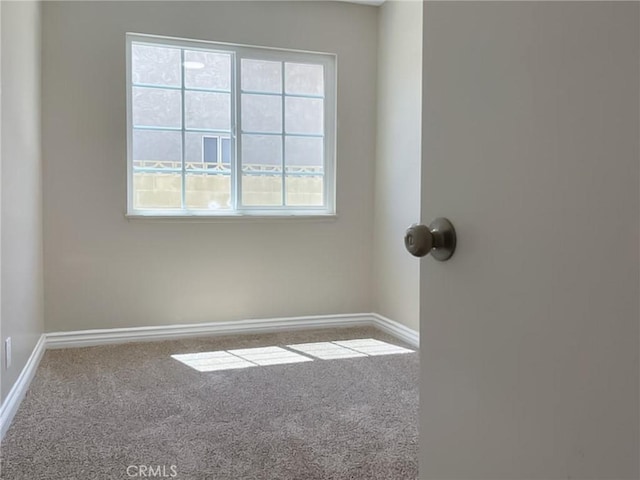 unfurnished room with carpet flooring