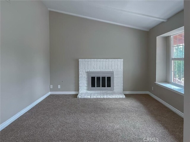 unfurnished living room featuring a brick fireplace and carpet flooring