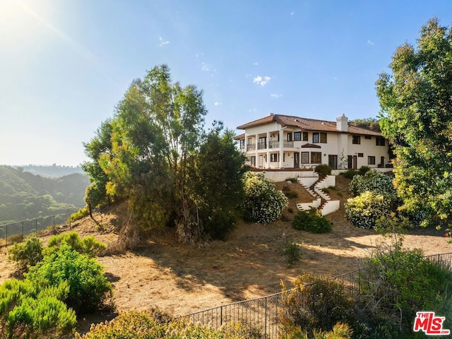 back of property with a mountain view