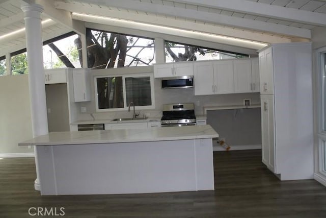 15814 Septo St, North Hills, CA 91343 - kitchen with stainless steel appliances, a sink, dark wood-type flooring, light countertops, and baseboards