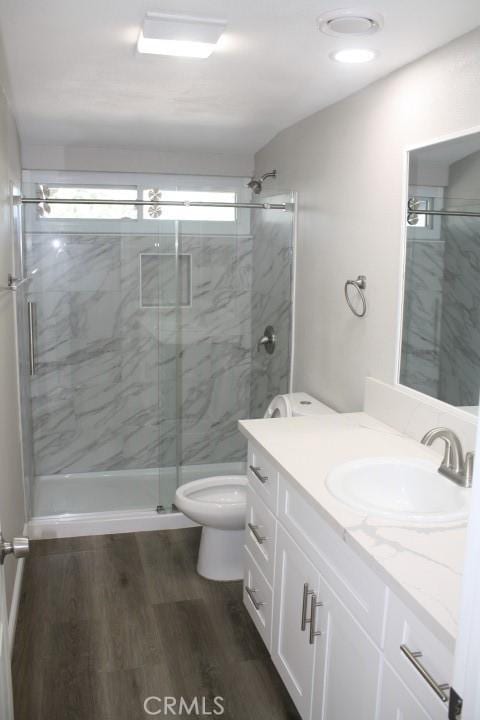 15814 Septo St, North Hills, CA 91343 - bathroom featuring toilet, a marble finish shower, wood finished floors, and vanity