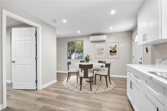 15814 Septo St, North Hills, CA 91343 - dining space featuring a wall unit AC, baseboards, light wood finished floors, and recessed lighting