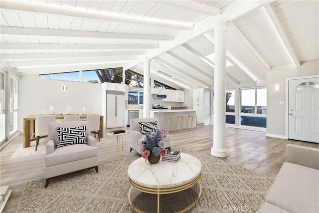 sunroom / solarium with decorative columns and lofted ceiling with beams