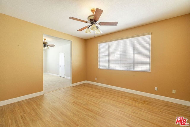 unfurnished room with ceiling fan, a textured ceiling, and light hardwood / wood-style flooring