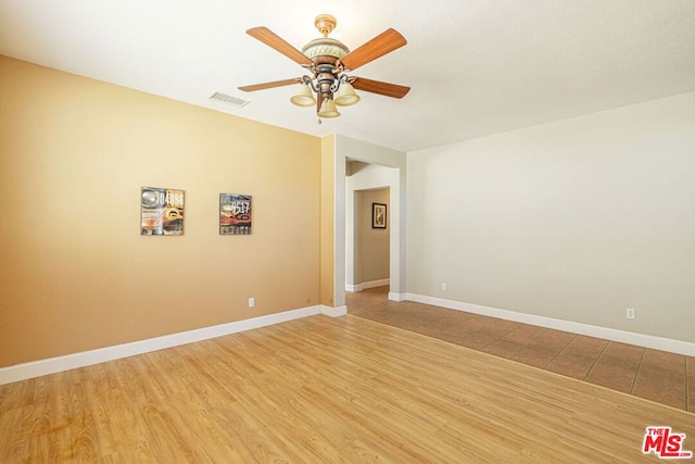 unfurnished room with hardwood / wood-style flooring and ceiling fan