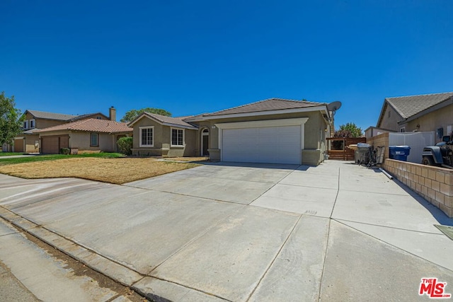 ranch-style home featuring a front yard and a garage