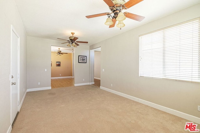 carpeted empty room with ceiling fan