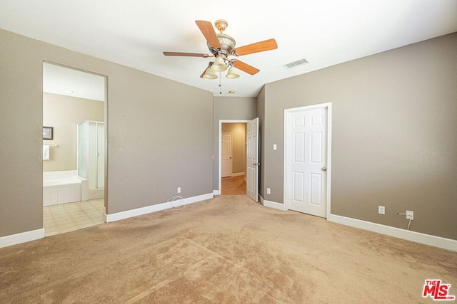 unfurnished bedroom with light carpet, connected bathroom, and ceiling fan