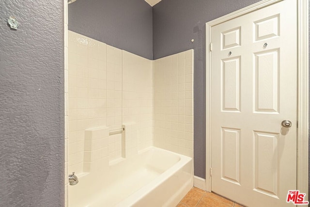 bathroom with tile patterned floors and shower / tub combination