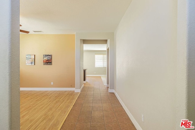 corridor with wood-type flooring