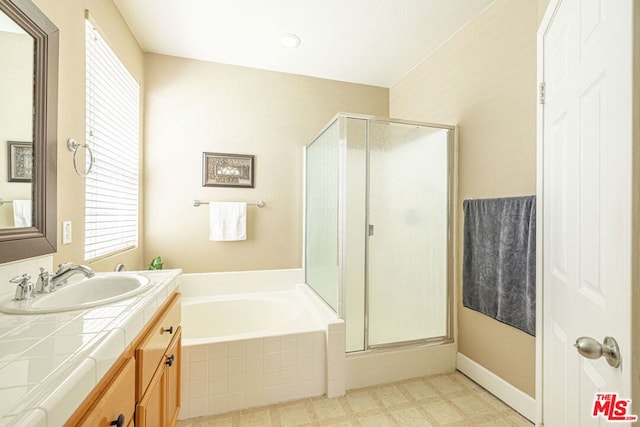 bathroom featuring shower with separate bathtub and vanity