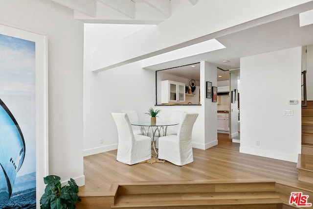 dining space with hardwood / wood-style floors