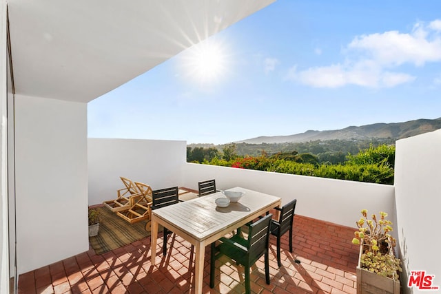 exterior space with a mountain view and a patio area