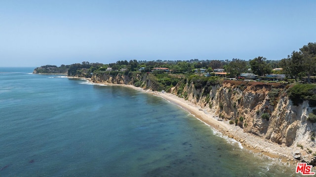 birds eye view of property with a beach view and a water view