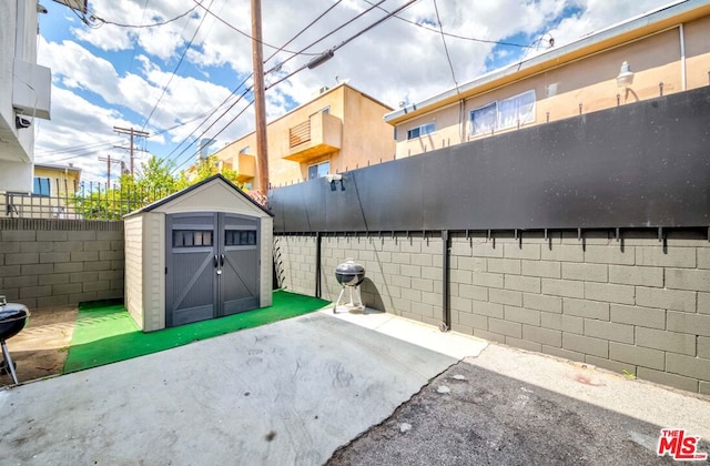 view of patio / terrace featuring a storage unit