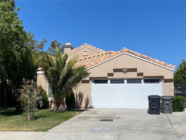 mediterranean / spanish-style home with a garage