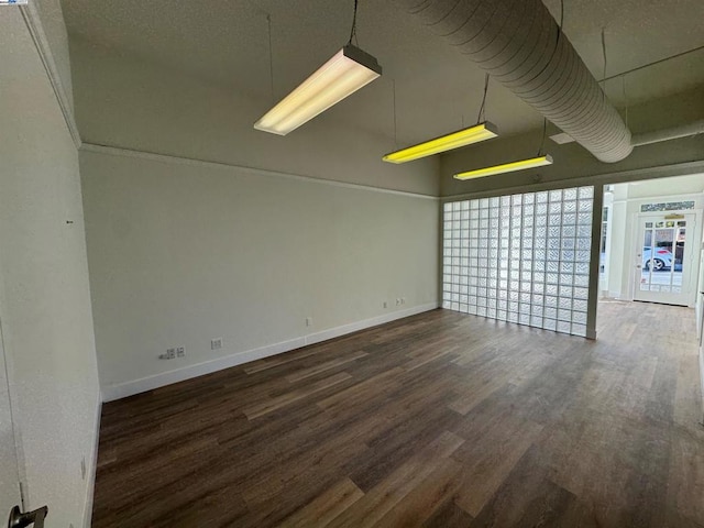 spare room featuring dark wood-type flooring