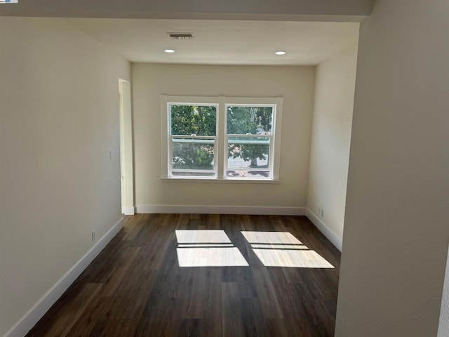 unfurnished room with dark hardwood / wood-style floors