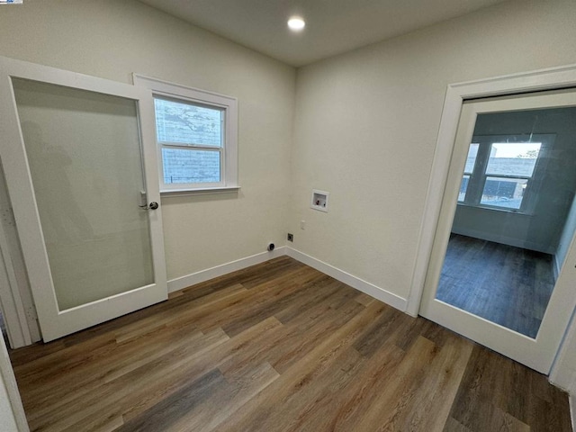 laundry area with hookup for a washing machine, hardwood / wood-style floors, a healthy amount of sunlight, and hookup for an electric dryer