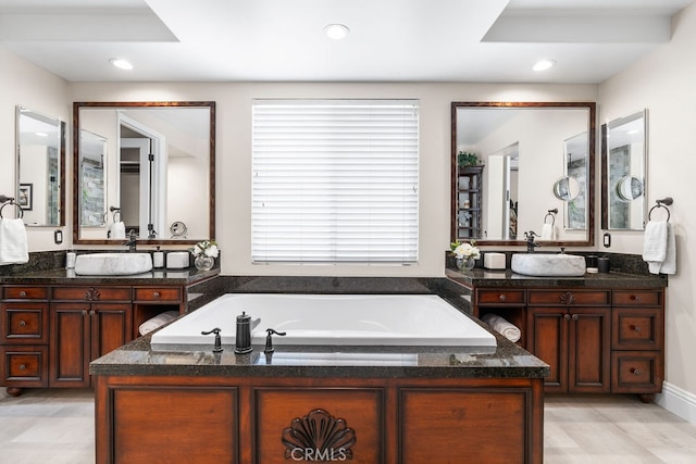 bathroom featuring vanity and a bath