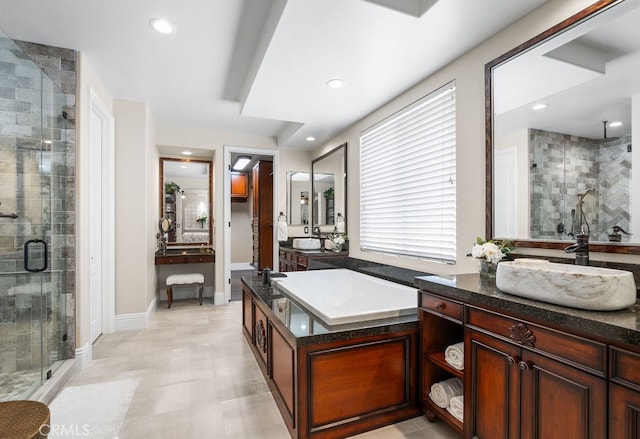 bathroom with vanity and separate shower and tub