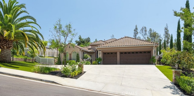 mediterranean / spanish-style home featuring a garage