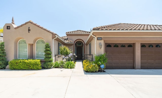 mediterranean / spanish house with a garage