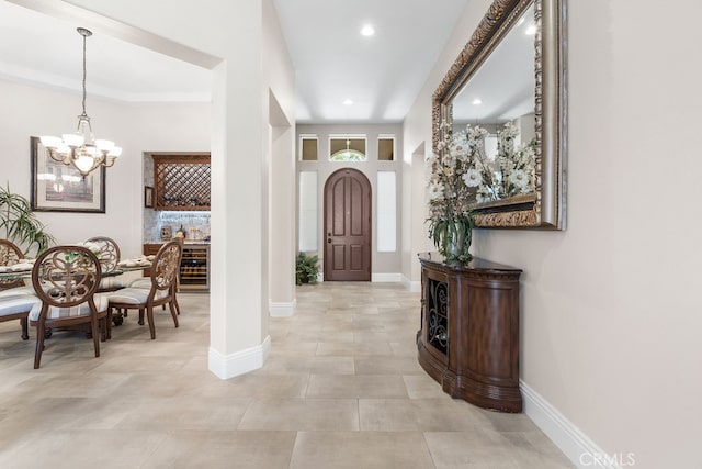 entryway with an inviting chandelier and wine cooler