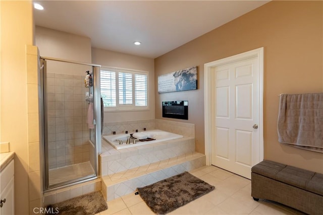 bathroom featuring tile patterned floors, vanity, and shower with separate bathtub