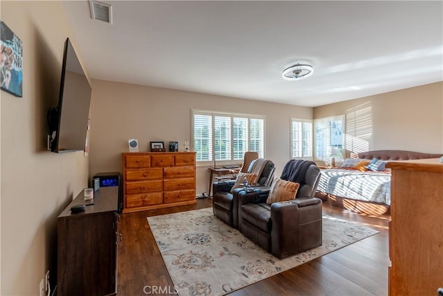 bedroom with dark hardwood / wood-style flooring