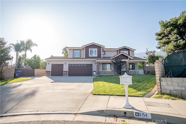 view of front of home with a front yard and a garage