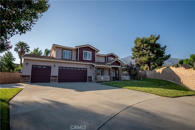 craftsman inspired home featuring a front yard and a garage