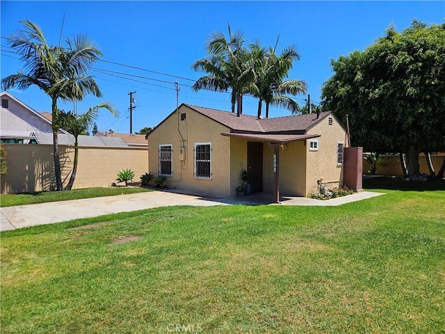 back of house with a lawn