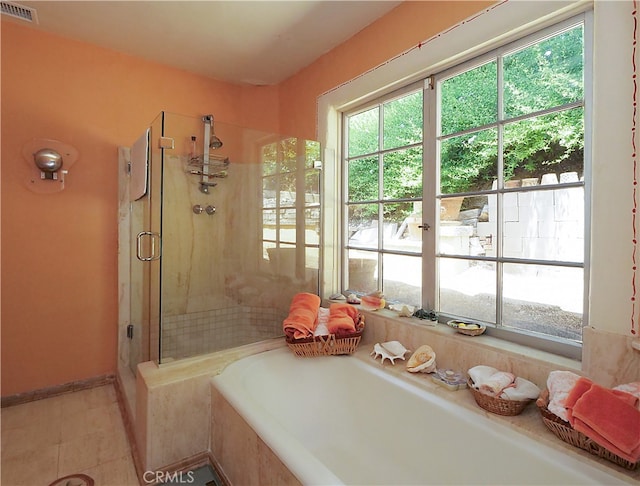 bathroom with shower with separate bathtub and tile patterned floors