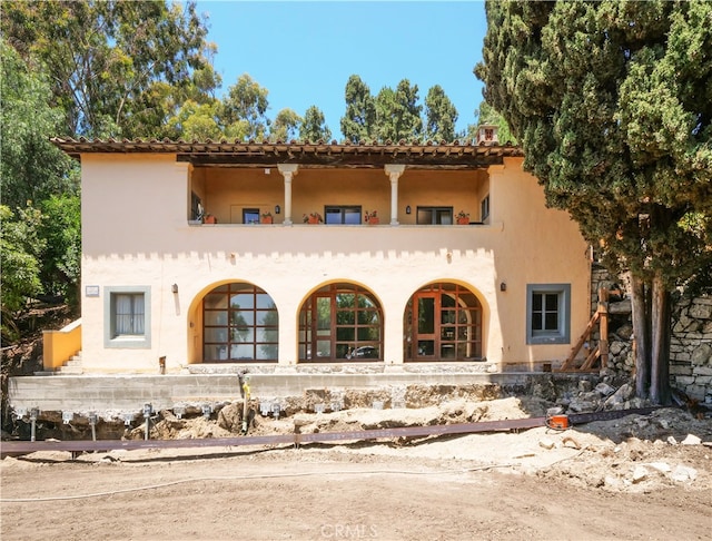 back of house with a balcony