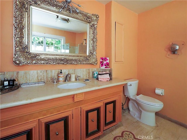 bathroom featuring vanity, toilet, and tile patterned flooring