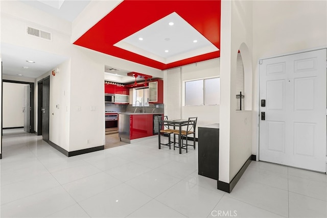 4301 Fulton Ave Unit 301, Sherman Oaks, CA 91423 - kitchen featuring stove, a sink, baseboards, arched walkways, and dishwashing machine