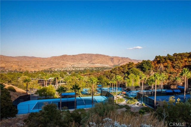 exterior space featuring a mountain view and tennis court