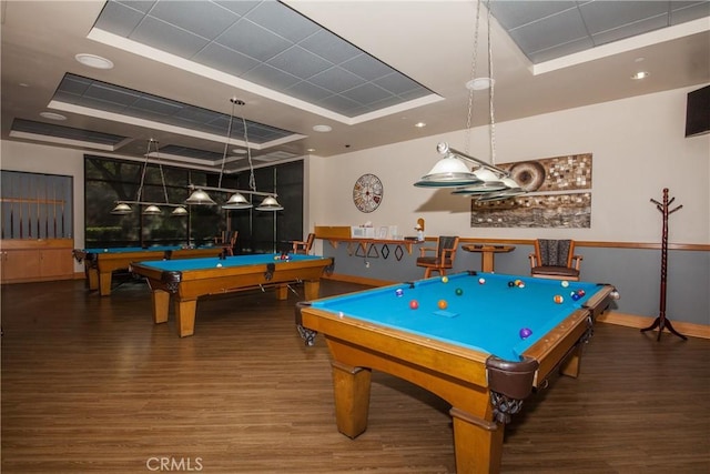 rec room featuring a tray ceiling, wood-type flooring, and pool table