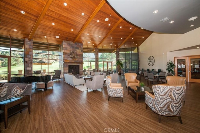 living room with a stone fireplace, wood ceiling, high vaulted ceiling, dark hardwood / wood-style flooring, and beamed ceiling