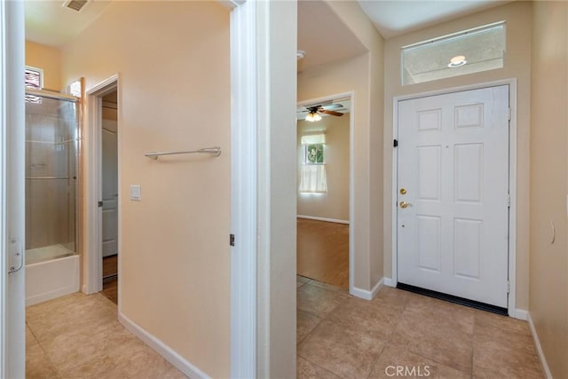 entrance foyer with light tile patterned flooring and ceiling fan