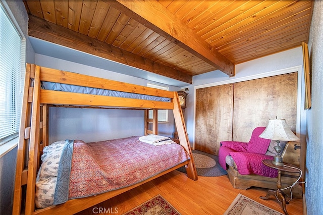 bedroom featuring wood ceiling, wood-type flooring, and beam ceiling