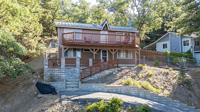 rear view of property with a wooden deck