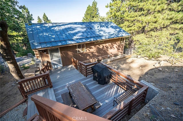 wooden terrace featuring a grill