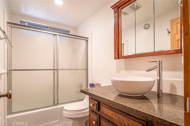 full bathroom featuring shower / bath combination with glass door, vanity, and toilet