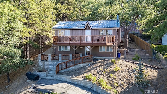 back of house featuring a wooden deck