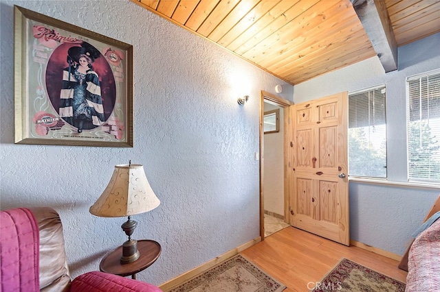 living area with wood ceiling and light wood-type flooring