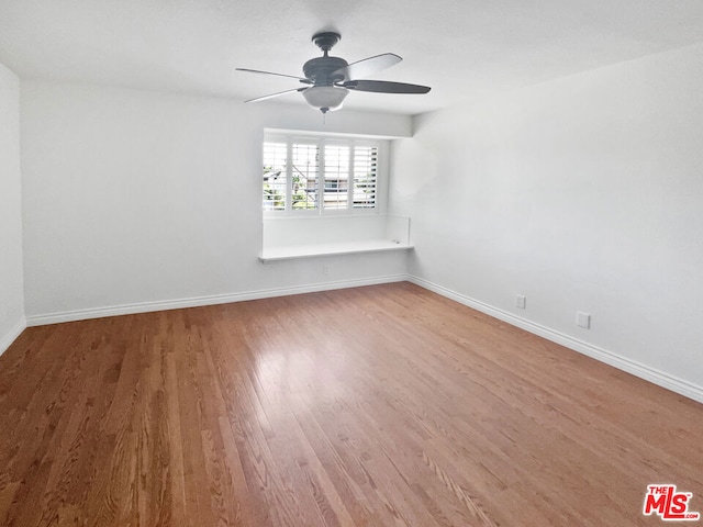 empty room featuring ceiling fan and hardwood / wood-style floors