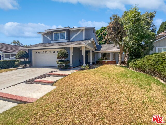 view of front property with a front lawn and a garage